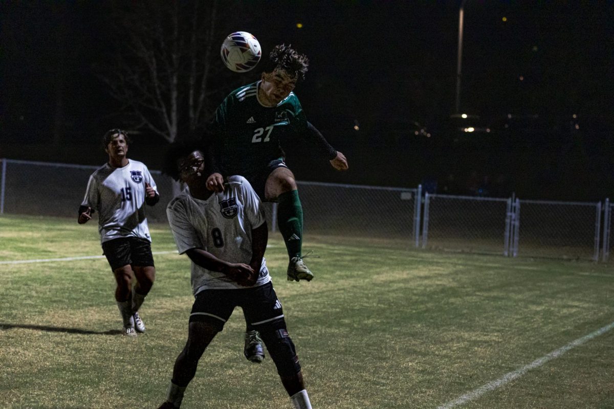 Atanas Milchev jumping over opponent to head the ball. 