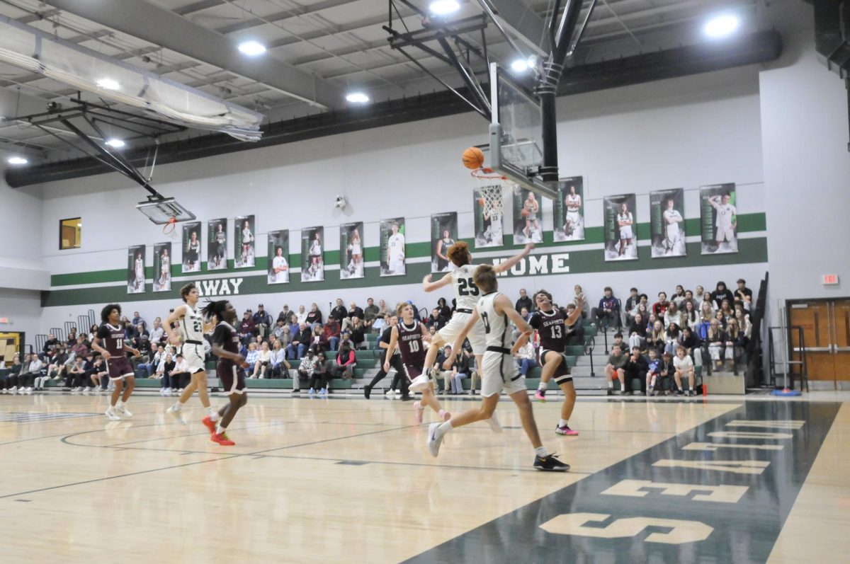 Sophomore Campbell Blackburn scores at boy's basketball game