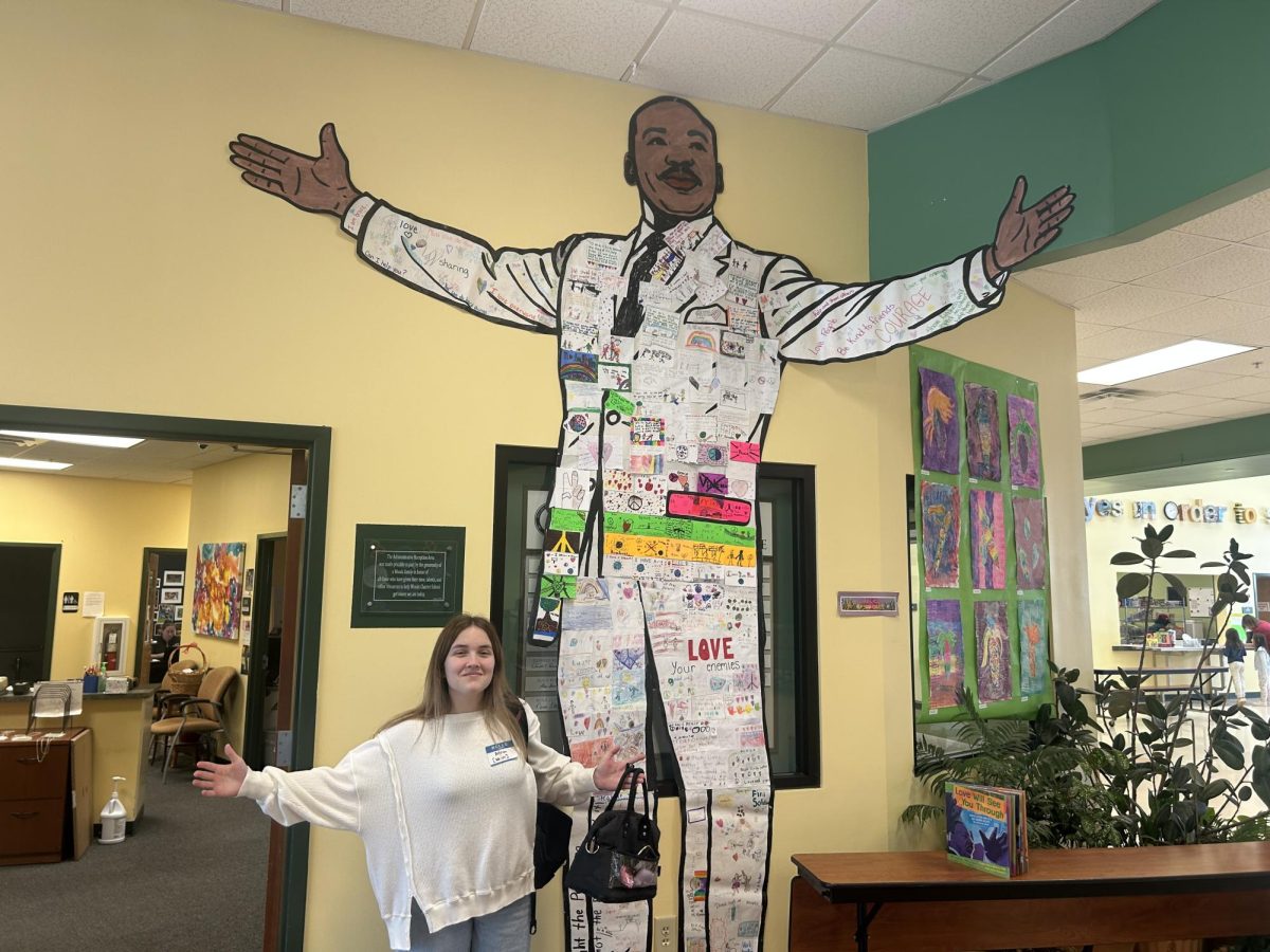 Elementary students come together to create an image of MLK, Senior Anna Robards for scale