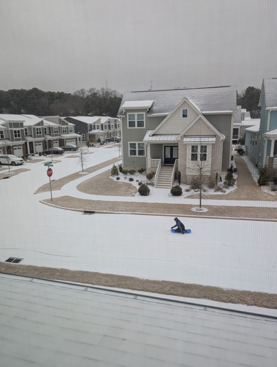 Junior Satya Amirneni sleds down his driveway.