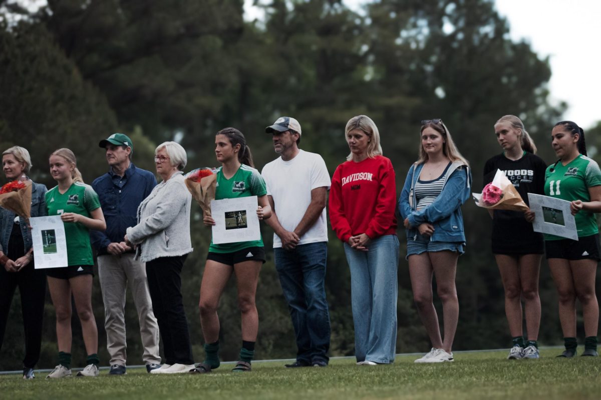 Senior players (L-R) Wesley Oliver, Paige Apolito, and Sarah Dalli with their families and friends celebrating for senior night